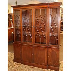 a large wooden china cabinet with glass doors