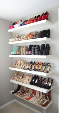 a white shelf filled with lots of shoes