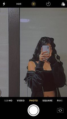 a woman taking a selfie in front of a mirror