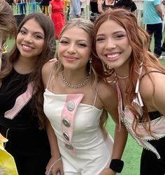 three girls are posing for the camera with one another