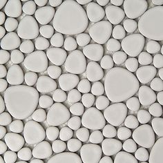 the white pebbles are arranged on top of each other in this mosaic tile wall pattern