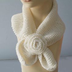 a crocheted white scarf with a rose on the front and center piece in the middle