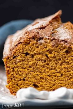 a loaf of pumpkin bread with powdered sugar on top and one slice cut off