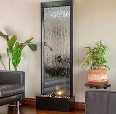 an indoor fountain in the corner of a living room