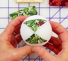 someone is making a christmas ornament out of fabric