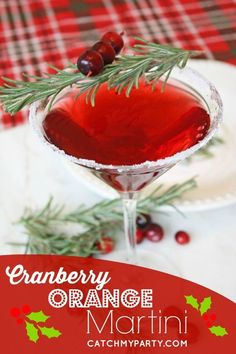 cranberry orange martini is garnished with an evergreen sprig and red berries