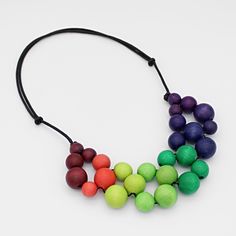 "Looking for a statement necklace that's both eye-catching and comfortable to wear? Look no further than Sylca Designs' adjustable length necklace! Made from lightweight materials and featuring colorful ombre beads, this simple yet striking piece is sure to turn heads wherever you go. Adjustable Length: 18\"-26\"  Beads: .25\"- .5\" D  Care Instructions: Remove jewelry when applying perfumes, creams, washing hands etc. Do not store in direct sunlight. To restore color and shine apply a drop of o Multicolor Wooden Beads Necklaces For Jewelry Making, Multicolor Wooden Beads For Jewelry Making, Unique Multicolor Wooden Beads Necklaces, Adjustable Bib Necklace With Colorful Round Beads, Rainbow Beaded Necklaces With Wooden Beads As Gift, Colorful Adjustable Necklaces With Wooden Beads, Rainbow Necklace With Round Wooden Beads, Adjustable Rainbow Beaded Necklaces With Wooden Beads, Adjustable Rainbow Beaded Necklace With Wooden Beads