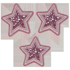 three pink and white stars with sequins on them