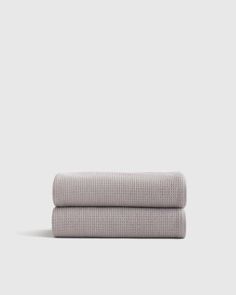 two grey towels folded on top of each other