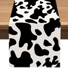 a black and white cow print table runner