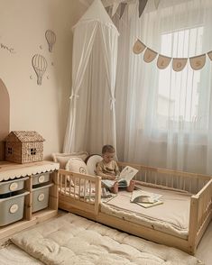 a little boy sitting in his bed reading a book