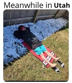 a man laying on top of a snow covered ground next to a wooden fence with the caption meanwhile in illinois