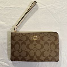 Nwt Classic Coach Wristlet Elegant Brown Wristlet For Everyday Use, Elegant Brown Wristlet For Daily Use, Coach Beige Clutch Wristlet, Beige Travel Wristlet With Wrist Strap, Beige Wristlet With Wrist Strap For Travel, Brown Handheld Wristlet With Zipper Pouch, Elegant Brown Wristlet With Removable Pouch, Beige Wristlet For Daily Use, Beige Wristlet With Wrist Strap