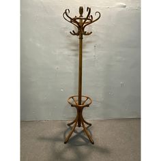 a coat rack with two umbrellas on it and a lamp hanging from the top