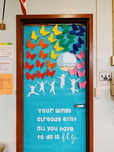 a classroom door decorated with colorful paper cut outs and words that read, your wings already exist all you have to do is fly