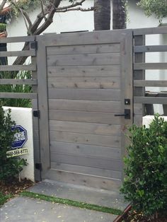 a wooden gate in front of a house