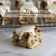 cinnamon swirl raisin biscuits with icing sitting on top of a white paper towel