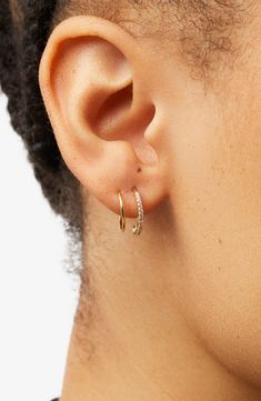 Want the look of a second piercing without the commitment? These double hoop earrings are for you. Dipped in 14k gold, they have one cubic zirconia-encrusted half and one metal half, adding just the right amount of sparkle to your look. How to wear: place thinner post through piercing. Turn earring approximately 2-3 times until both hoops are showing in the front to make a perfect double-pierced look. Avoid bending, style is delicate. How to wear: place thinner post through piercing. Turn earrin Second Ear Piercing Loop, Double Lobe Piercing, Second Ear Piercing, Second Piercing, Double Hoop Earrings, Lobe Piercing, Bending, Ear Piercings, Cubic Zirconia