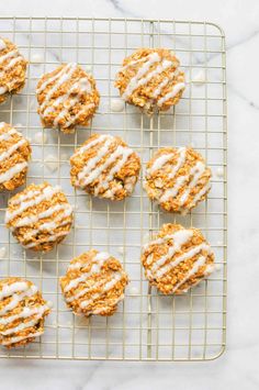 freshly baked cookies with white icing on a cooling rack, ready to be eaten