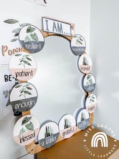 a mirror sitting on top of a wooden table next to a box with magnets