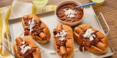 hot dogs with chili and cheese on a tray