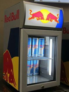 a red bull cooler with cans of soda in it