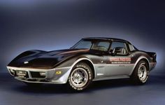 a black and silver sports car on a blue background