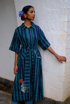 Did someone say chic? Our Javitri dress has an oversized, shirt-style silhouette and a tie up belt to cinch in your waist. It has a structured vibe with its boxy sleeves,and quirky embroidery details. We believe you have a right to know how this product was made. 3.5 metres of south Indian mangalgiri cotton fabric sourced from Jaipur has been used for this piece. Hand printed by our artisans in Jaipur, manufactured in our workshop at Pune, India. This product is hand-printed in Jaipur, India using techniques of traditional hand block printing. Subtle variations in patterns are natural to this process. We believe this makes each creation unique and charming. If you wish to have the length of the garment altered, please mention your request in the special instructions section at checkout, wi Cotton Collared Shirt Dress With Tie Waist, Collared Cotton Shirt Dress With Tie Waist, Cotton Shirt Dress With Belted Cuffs, Cotton Belted Shirt Dress Midi Length, Summer Cotton Shirt Dress With Belted Cuffs, Cotton Midi Dress With Belted Cuffs, Belted Collared Shirt Dress In Cotton, Cotton Dresses With Belted Cuffs, Half Sleeve Cotton Shirt Dress For Work