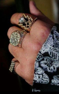 a person wearing three different rings on their hand