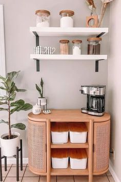 a kitchen with white walls and wooden shelves