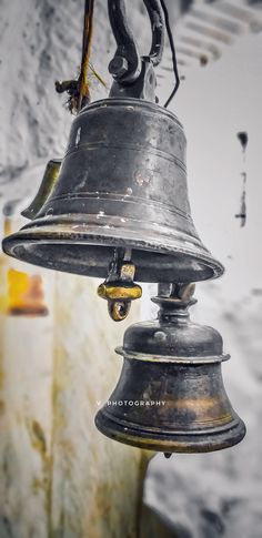 an old metal bell hanging from the ceiling