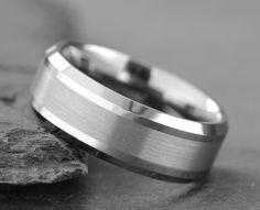 a wedding ring sitting on top of a rock