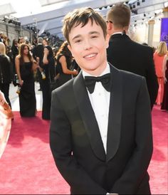 a young man in a tuxedo on the red carpet