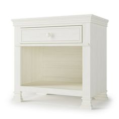 a white night stand with two drawers on one side and an open drawer on the other