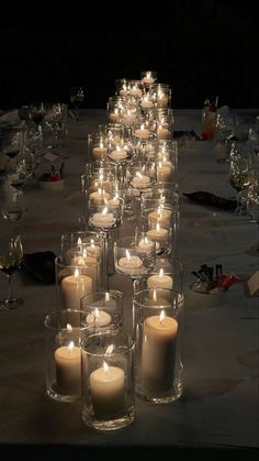 a long table with many lit candles on it