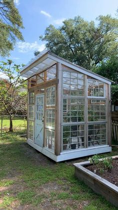 a small greenhouse in the middle of a yard