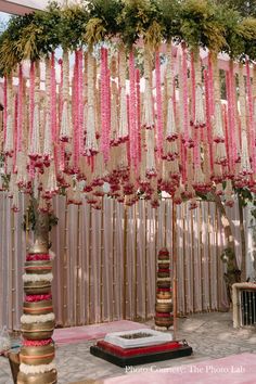 an outdoor ceremony with pink and gold decorations