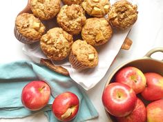 some apples and muffins are on a table