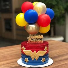 a birthday cake with balloons on top