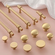 brass door handles and knobs on a pink surface