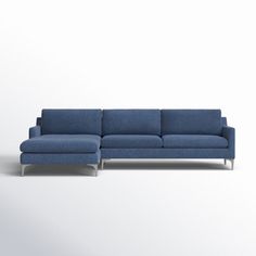 a blue sectional couch sitting on top of a white floor