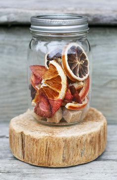 a jar filled with dried fruit sitting on top of a wooden table