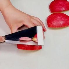 a woman is cutting apples with a pair of scissors