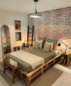 a bed made out of wooden pallets in a room with brick walls and flooring