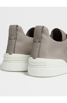 The Secondskin Triple Stitch sneaker features a glove-leather upper for mold-to-your-foot comfort and is mounted on an extralight rubber sole for a sleek look. The brand’s signature crossover elastic straps ensure an easy slip-on fit. Pull-on style with elastic laces Leather upper and lining/synthetic sole Made in Italy Designer Shoes Leather Slip-on Sneakers With Vibram Sole And Round Toe, Modern Leather Slip-on Sneakers With Vibram Sole, Leather Slip-on Sneakers With Vibram Sole, Leather Low-top Slip-on Sneakers With Vibram Sole, Functional Leather Custom Sneakers, Functional Leather Custom Sneakers With Vibram Sole, Leather Slip-on Sneakers With Vibram Sole For Sports, Functional Leather Low-top Slip-on Sneakers, Functional Low-top Leather Slip-on Sneakers