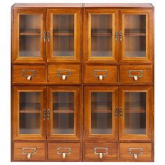 a wooden cabinet with glass doors and drawers