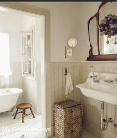 a bathroom with a tub, sink and mirror in it's centerpieces