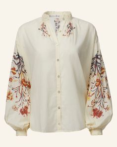 Individually cut by hand, our floral motif shirt has a ruffled collar and cuffs, a mother-of-pearl button front, and dramatically gathered sleeves. Crafted in a cotton voile, the vintage-inspired folk shirt has a semi-sheer texture perfect for those days when you feel like wearing nothing at all. This one-of-a-kind textile was block-printed by hand. Subtle printing and dye variations are part of the unique beauty of the garment and a signature of the artisan's hand. Embroidery Runway, Lily Valley, Sheer Texture, Fall Sewing, Nothing At All, Top Ideas, Gathered Sleeves, Ruffled Collar, Unique Beauty