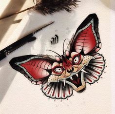 a drawing of a butterfly on top of a piece of paper next to a feather