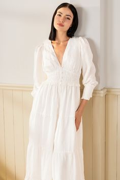 Georgia Maxi Dress will make a lasting impression at your next spring event! With an elastic waist, long sleeves, and tiered peasant skirt. LENGTH: 52" from top of shoulder FABRICATION: 100% White Linen STYLE#;DR-21450 White Linen - WHITE-S24﻿ *Dry Clean or wash on cold and hang flat to dry *Model is wearing size XS White Long-sleeved Midi Dress With Elastic Sleeves, Spring Midi Dress With Tiered Skirt And Gathered Sleeves, Spring Midi Dress With Gathered Sleeves And Tiered Skirt, White Tiered Dress With Smocked Bodice For Spring, White Long Sleeve Dress With Smocked Cuffs, Spring Tiered Dress With Elastic Sleeves, Spring Long Sleeve Peasant Dress With Smocked Back, White Tiered Smocked Dress For Spring, Spring Tiered Dress With Gathered Sleeves